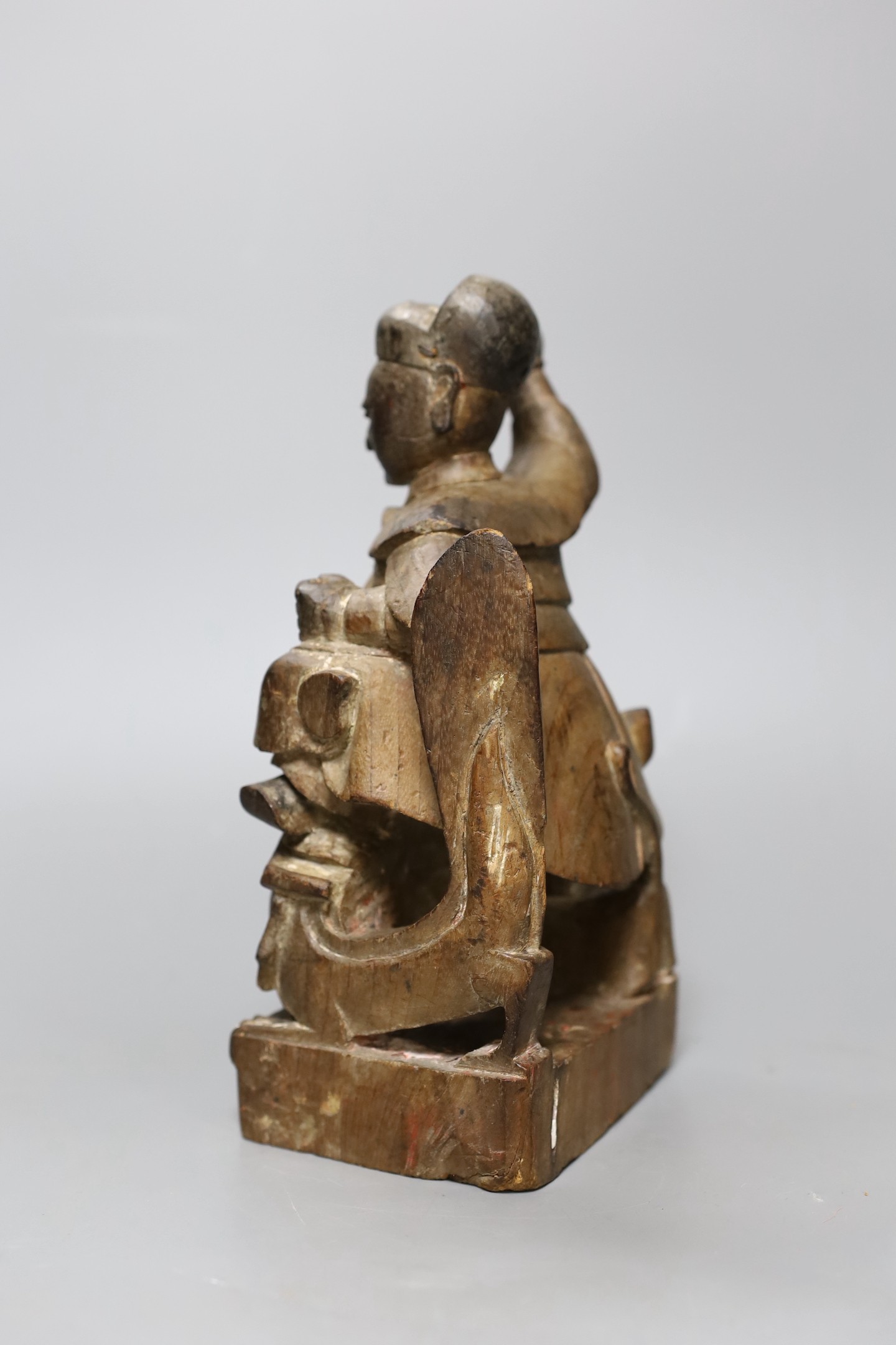 A Chinese Qing dynasty carved wood figure, 23cm tall